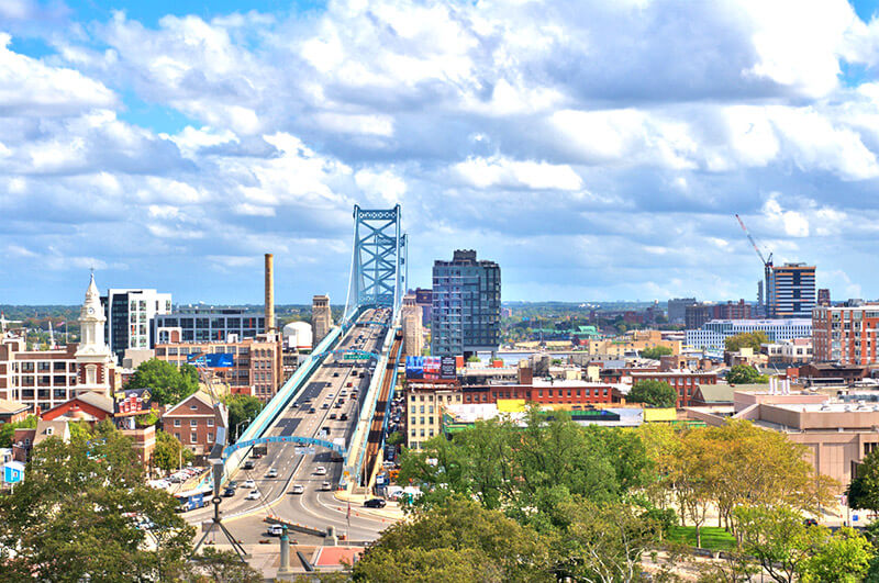 A photo looking east to the riverfront and Ben Franklin Bridge taken from the Metroclub condominium building's roof.